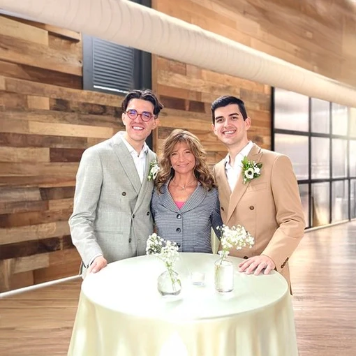 Two grooms with their officiant at an Indiana wedding